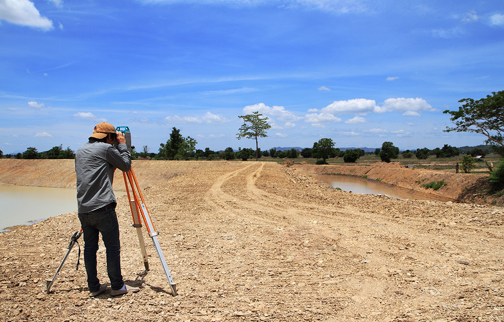 Land, man takes photo of building site