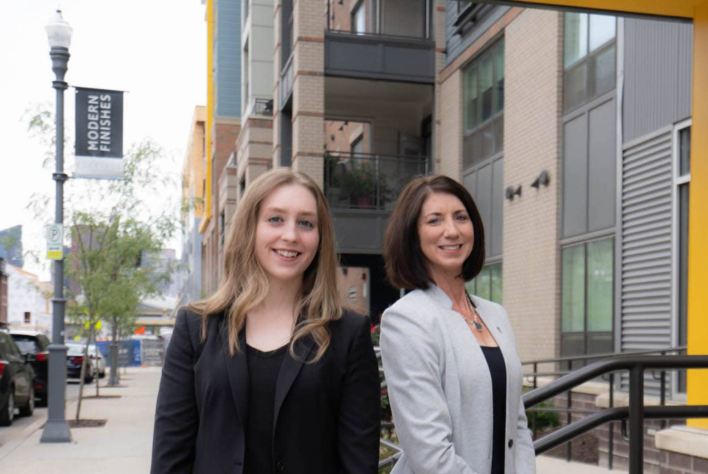 Kim Ford SIOR, LEED AP and Leigh Poulton standing in front of commercial office